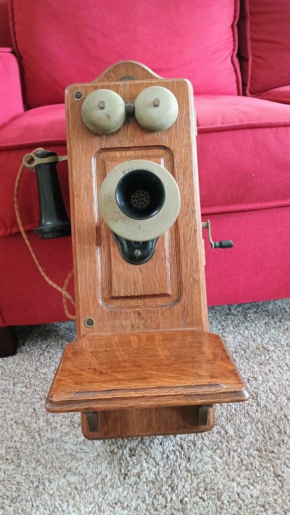 Vintage 1890's Oak Kellogg Cathedral Crank Phone includes a mouthpiece, a separate ear receiver, a hookswitch, a hand crank (used to generate a signal