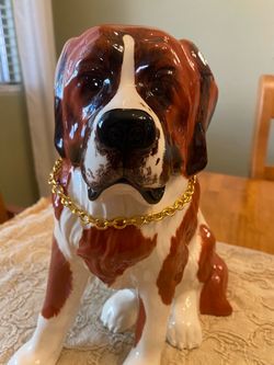 Vintage porcelain 11 x9 inch St Bernard dog statue with golden chain collar. Repaired right leg.