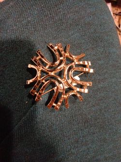 Gorgeous vintage 1972 gold tone brooch by Sarah Coventry called "Sea Sprite". It has a hammered look with several arches. It is 2" in length and 2" wi