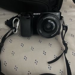 Sony a6000 mirrorless digital camera with two zoom lenses, carrying case, 2 batteries, and battery charger 