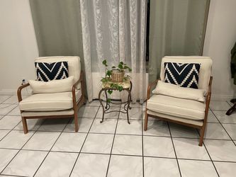 2 beige arm chairs