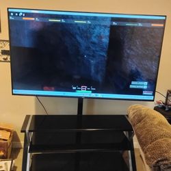 70 Inch TV With Swivable Entertainment Stand 