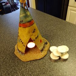 METAL. TEE PEE.  TEA LITE CANDLE HOLDER.   10 INCHES TALL.  8 IN. WIDE.    SAND FLOOR. ITS COOL