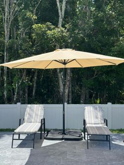 Pool loungers and umbrella