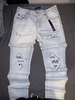 Amiri Light Wash Distressed Jeans with Leopard Patches