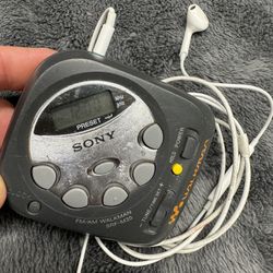 Vintage Compact Sony Am/FM Walkman with Apple Earpods w/Mic. Works great!  Runs on Two AAA.  