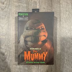 In Hand, Brand New, Never Opened NECA TMNT Teenage Mutant Ninja Turtles - Universal Monsters - Michelangelo as The Mummy - 7” Action Figure