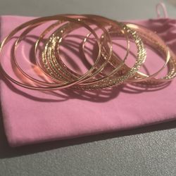 Enhance your style with this elegant gold bangle set. Perfect for any occasion, these bangles add a touch of sophistication to your outfit.