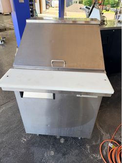 Vortex Refrigeration commercial sandwich prep table featuring a stainless steel exterior with a top cutting board surface.