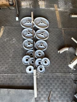 Olympic weights 255lbs total plus 7ft 45lbs bar