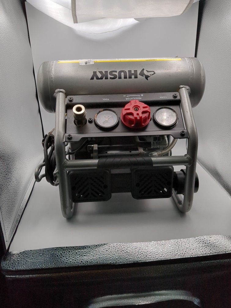 Husky 1 Gallon Portable Electric-Powered Silent Air Compressor. It is designed for small DIY projects and home improvement tasks. It features a 1/2 HP