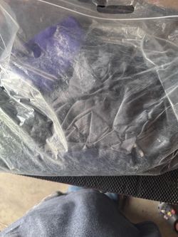 Bag is misc sports shirts, shorts and a beanie