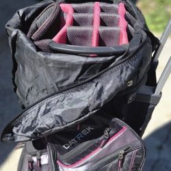 Datrek Transit Wheeled Cart golf bag in a black, charcoal, and pink color scheme. 
