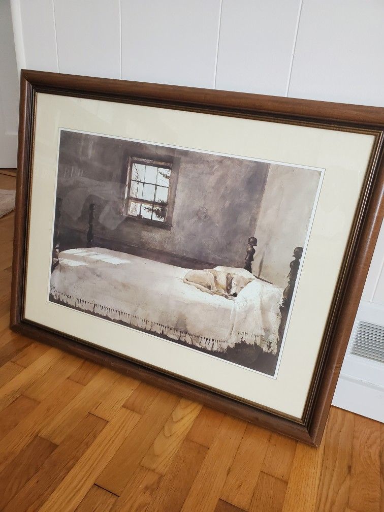 A dog in a bed Framed Art