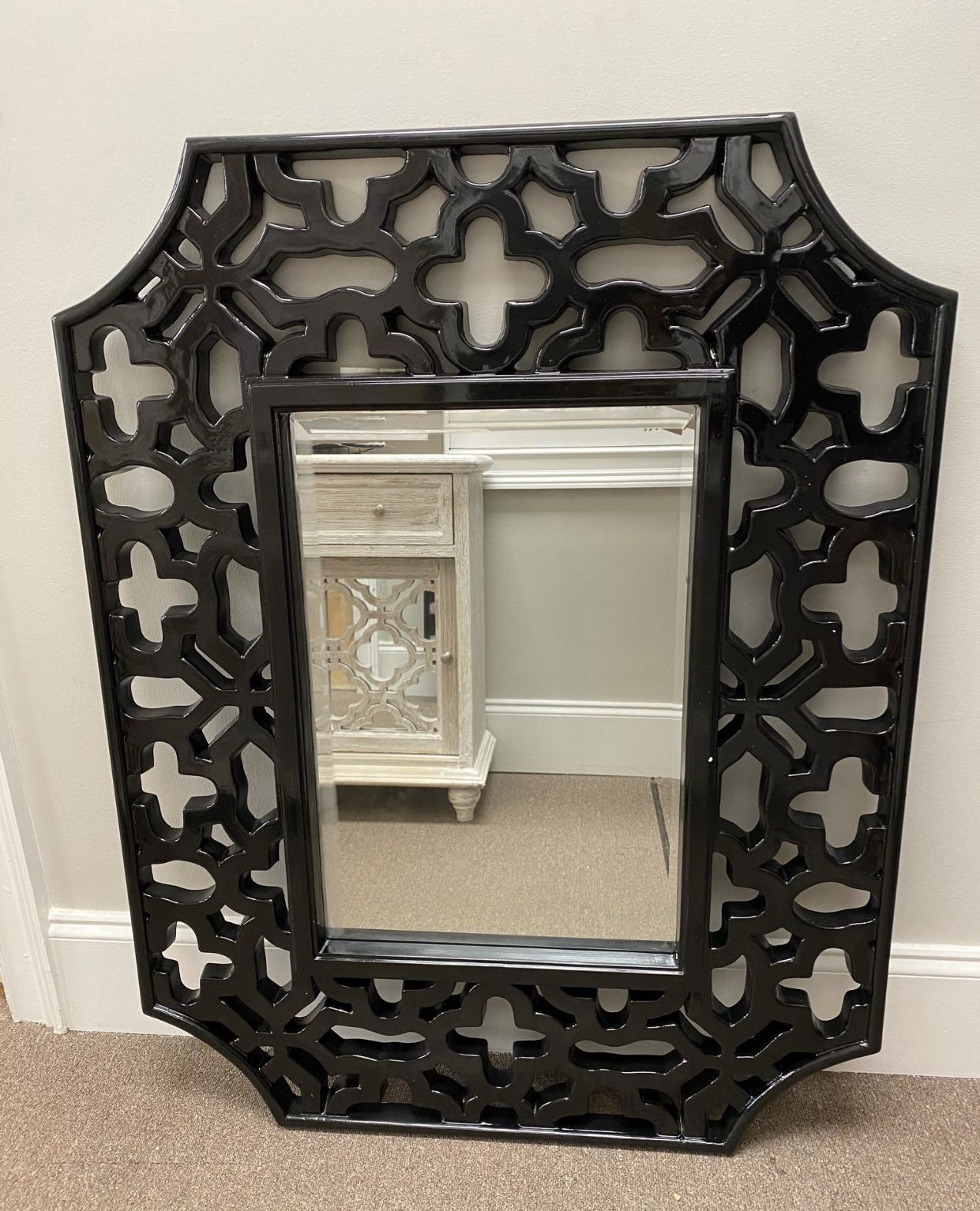 Olivia wall mirror. Overall: 43” H x 33” W x 1.5” D. HAS SMALL CRACK IN FRAME. Wall mounted. Frame design: ornate. Frame material: resin. Finish: blac
