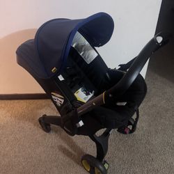 Doona Car Seat & Stroller + Base + Seat Protector (Expires 2029)