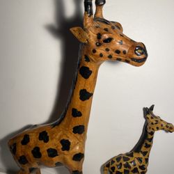 leather-wrapped giraffe figurines featuring glass eyes. 