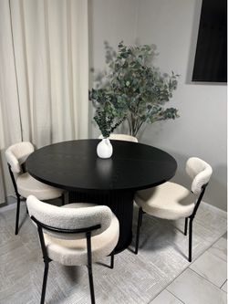 Black round fluted table with chairs