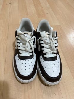 Woman’s brown and beige Air Force 1s, pandas and Reebok