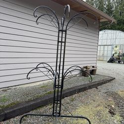 Large decorative metal plant stand holds 12 hanging baskets perfect for retail or personal use $100