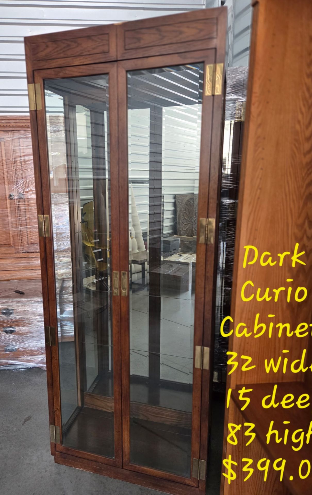 Curio Cabinet Dark w/Gold FinishWe are located at 2811 East Bell road. Another Time Around Furniture.
