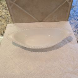 vintage white milk glass relish dish, often featuring a ribbed or hobnail texture and a scalloped or beaded rim.
