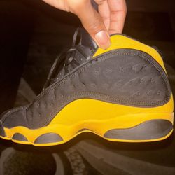 Yellow and black Jordan 13 trainers 