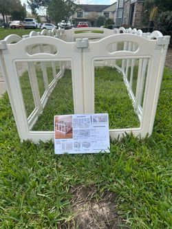 Modern indoor pet playpen featuring crystal-clear acrylic panels and a sturdy white frame for a 360-degree view.