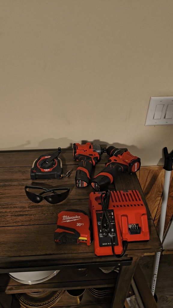 New Tools Two Batterys Charger Impact And Drill 100 Ft Tape 30 Ft Tape