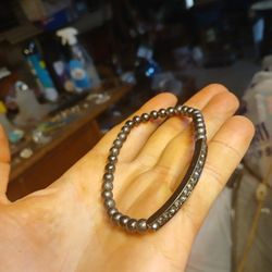 black or gunmetal-tone rhinestone stretch bangle bracelet. 