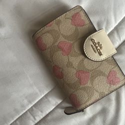 pink and tan coach wallet with hearts 