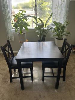 Small dark brown wooden dining table set
