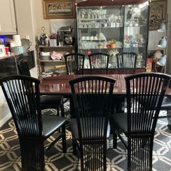 Italian dining room set includes elegant glossy brown table , eight leather chairs and china hutch 