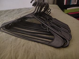 21 black plastic hangers
