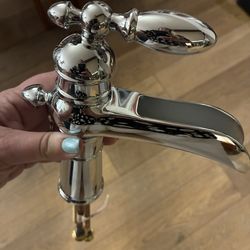 Delta Chrome Single Handle Bathroom Faucet And PivotingToilet Paper Holder