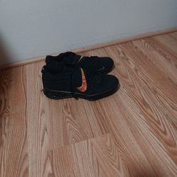 black Nike Force Zoom Trout 6 baseball cleats with an orange and yellow iridescent swoop. 