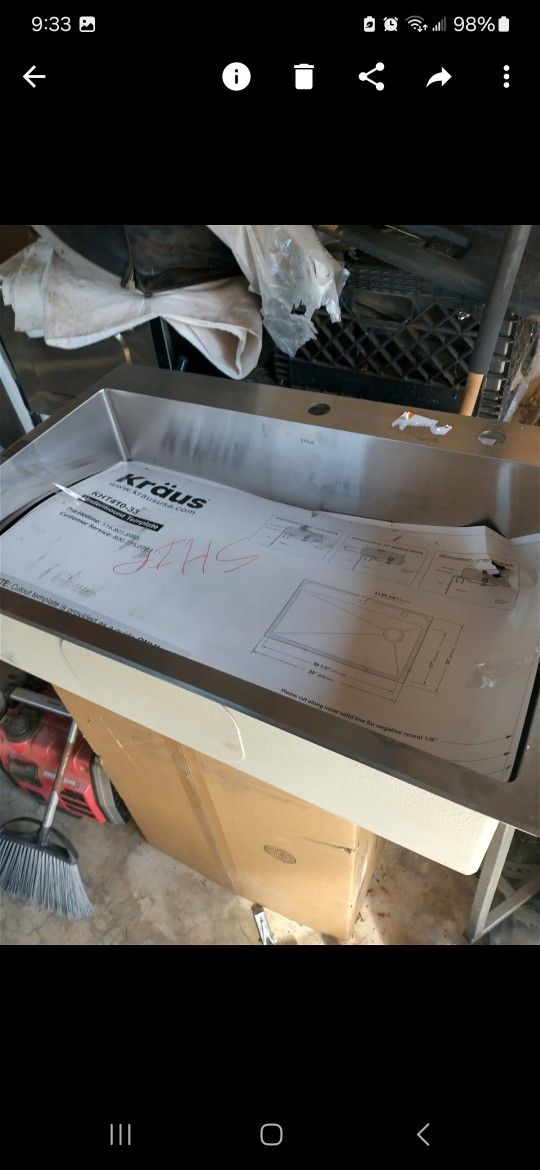 Kraus 30-in stainless steel kitchen sink with faucet and screen.
