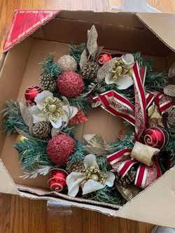 Christmas Wreath with Red & Gold Ornaments Festive Christmas wreath decorated with red and gold ornaments, pinecones, faux flowers, and bows. Comes i