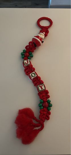 Vintage-style Christmas JOY hanging decoration featuring red macramé-style cord, ceramic Santa detail
