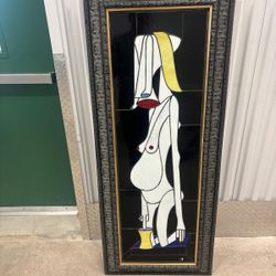 Decorative, stained glass panel framed as wall art, featuring a stylized, abstract figure reminiscent of Cubist art styles.  