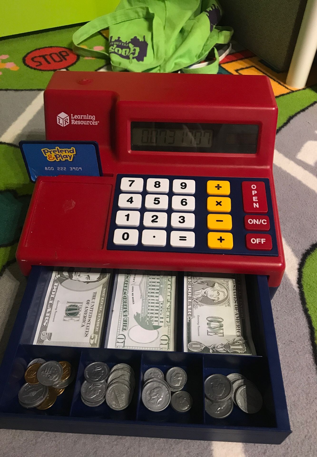 Pretend play cash register and calculator with fake coins and paper money. Perfect for teaching kids the concept of money.