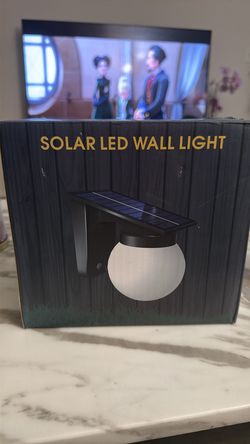 Solar LED Wall Light, featuring a spherical globe design powered by sunlight.