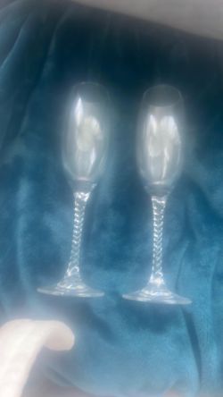 This is a clear glass Orrefors "Anne" pattern champagne flute with a twisted stem.
