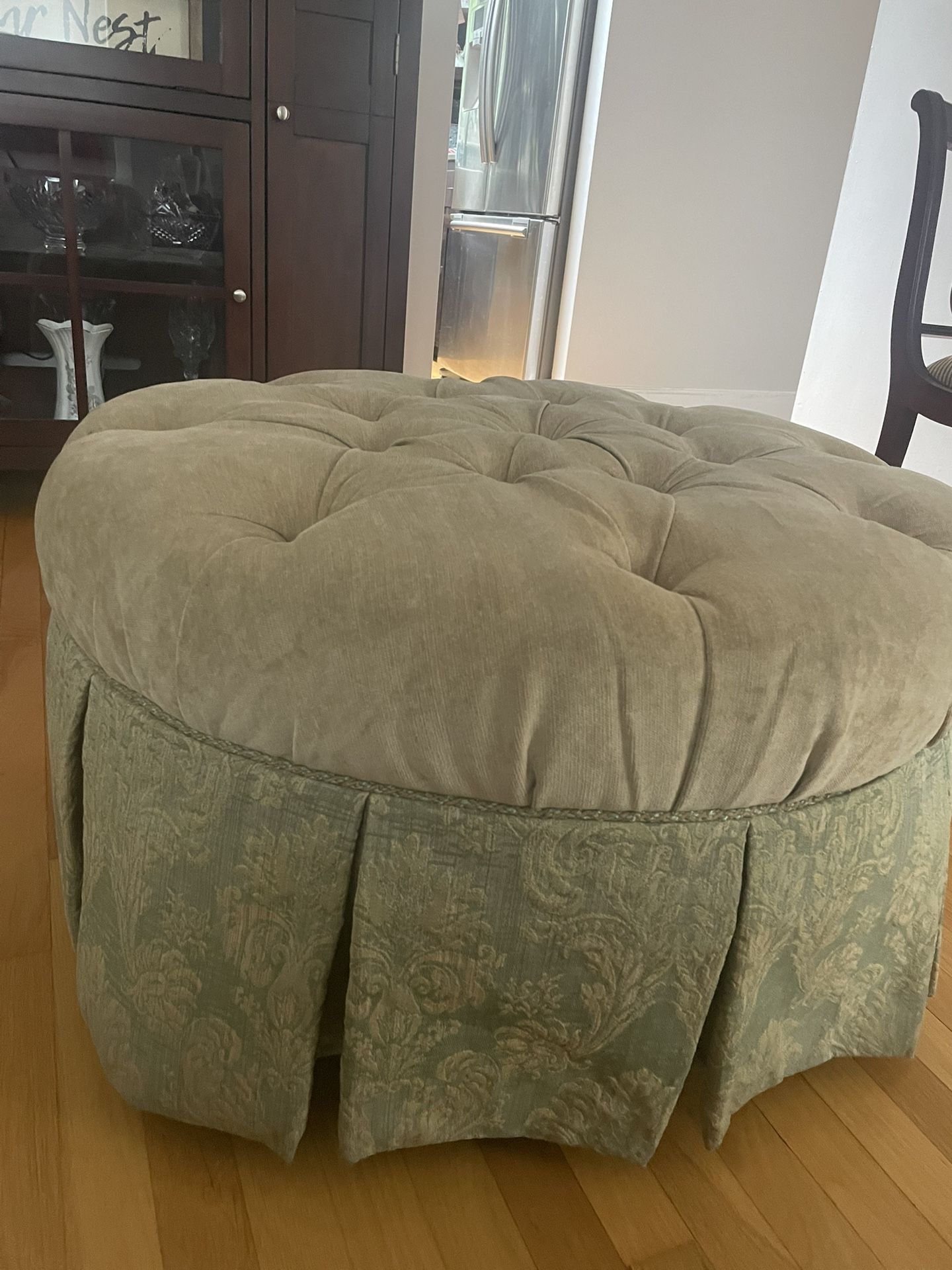 Rolling Ottoman With Tufted Cushion Top And Tapestry Trim Bottom