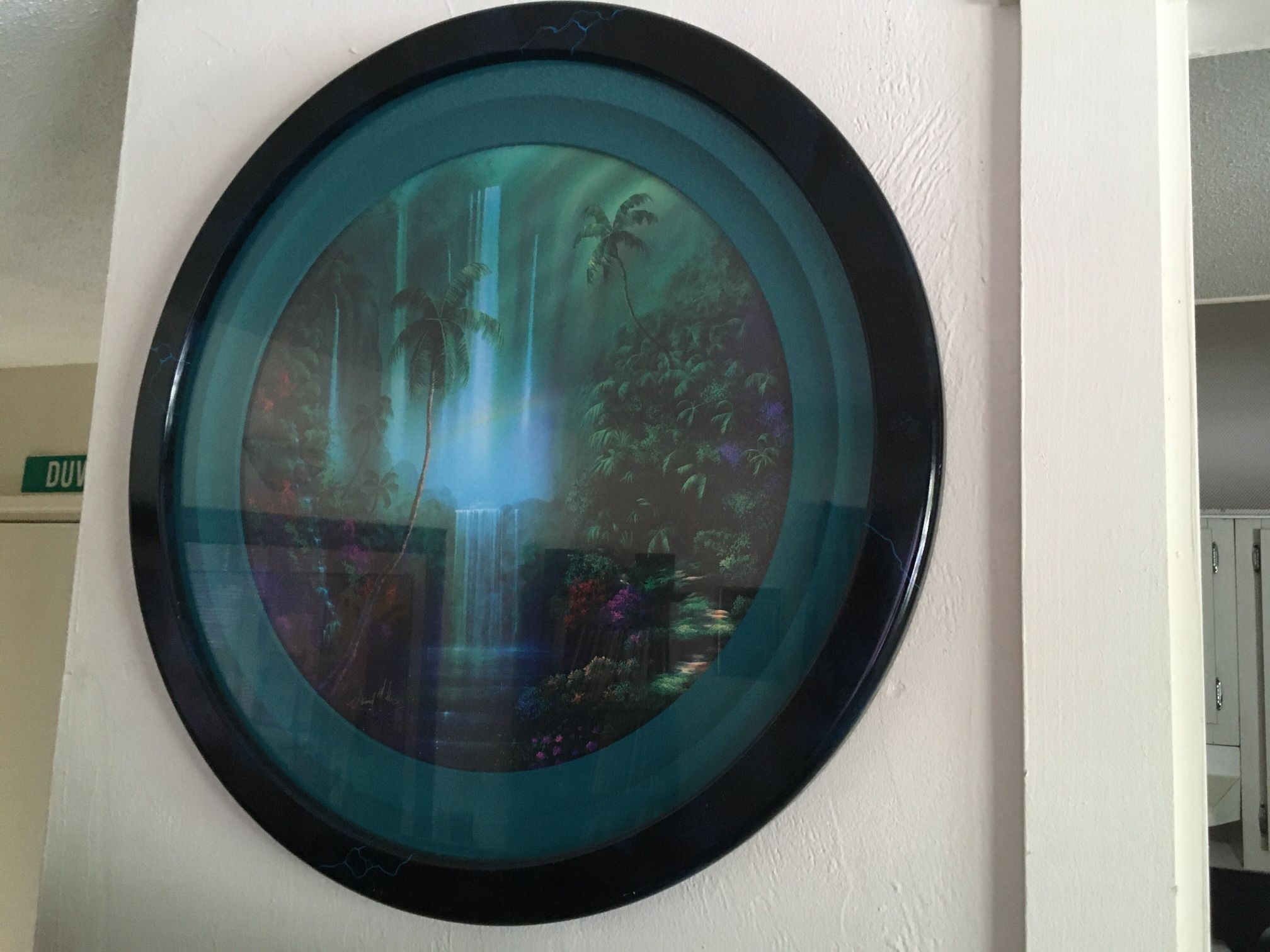 A David Miller tropical splendor print in round frame measures 29