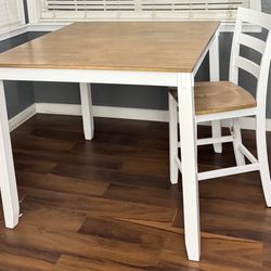 Breakfast bar with table and four high benches.