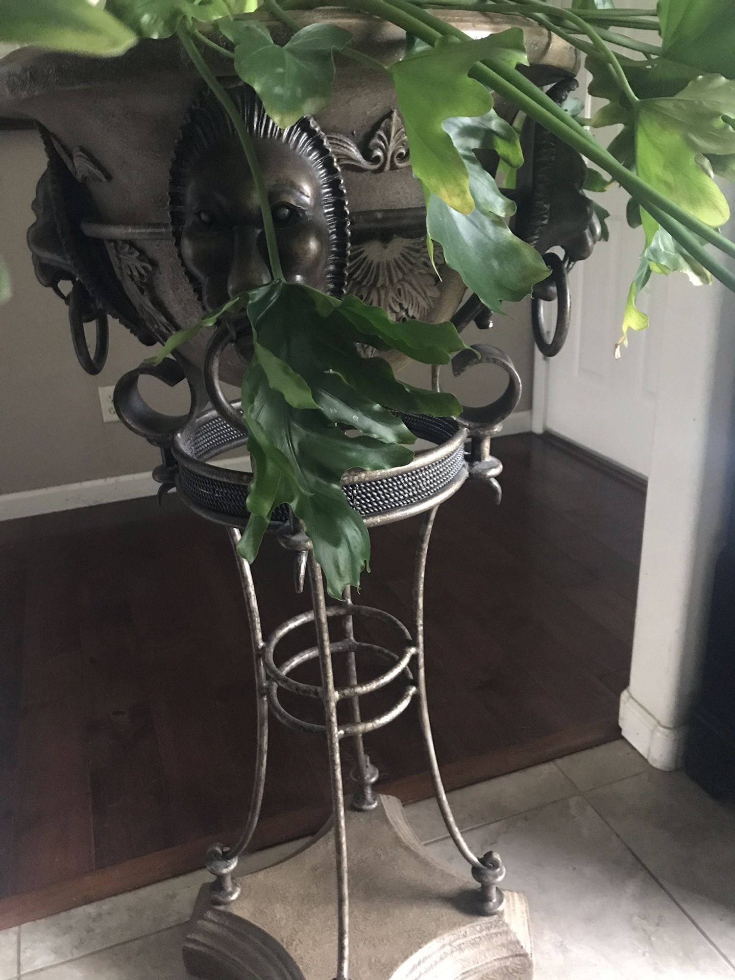 Ornate plant stand and pot . Plant is not for sale
