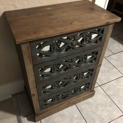 Beautiful wooden dresser with intricate carvings.