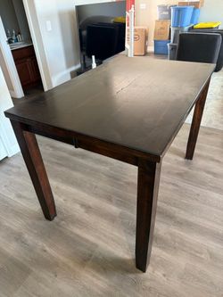 Brown wood dining table with lead