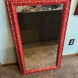 Really cool mid-century modern looking mirror with fiery red frame in great shape. No scratches nicks or dents on the frame or glass. Measures 23 inch